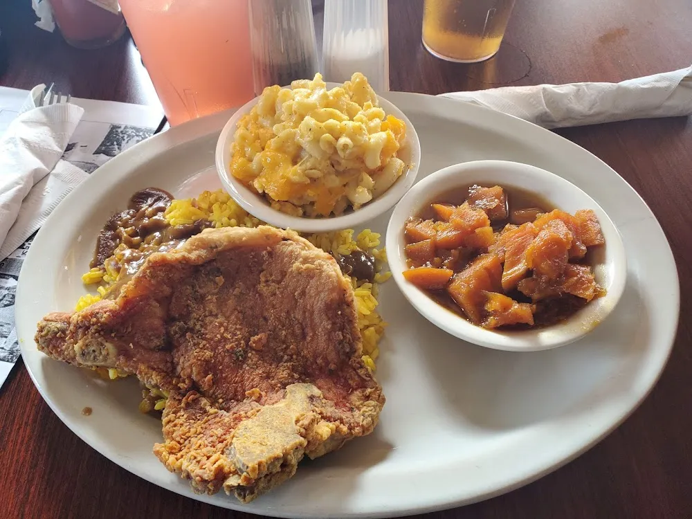 Fried Pork Chop Yellow Rice w Gravy Candy Yams Mac & Cheese and Corn Bread